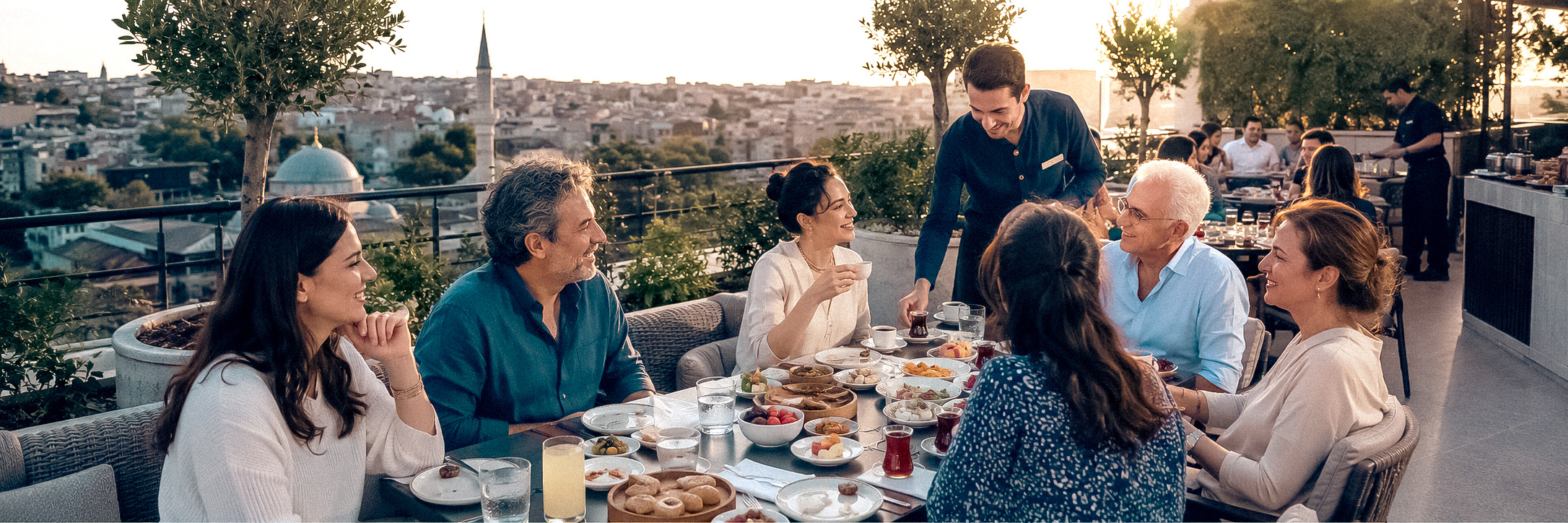 A large group of guests sharing breakfast and Turkish tea on The Central Hotel terrace